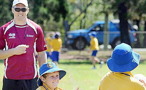 Former rugby league star Mick De Vere coaches Torquay State School students Sam Hooper and Lachlan Key at the Deadly Sports day. Former rugby league star Mick De Vere coaches Torquay State School students Sam Hooper and Lachlan Key at the Deadly Sports day.